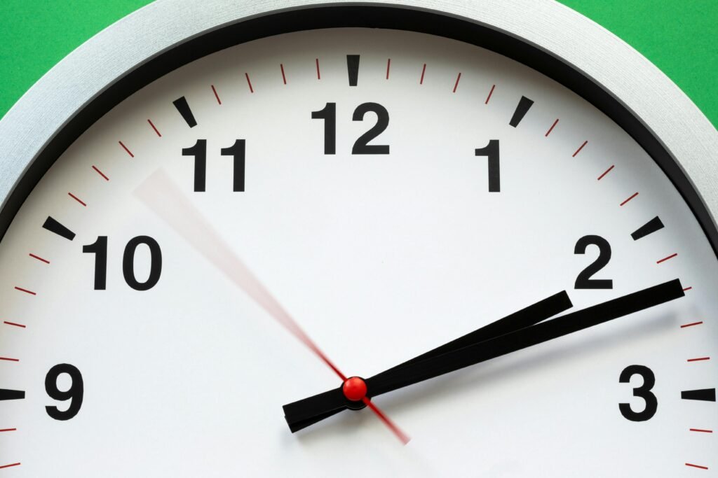 pexels-photo-1537268-1537268 A close-up image of an analog clock face showing time with blurred motion