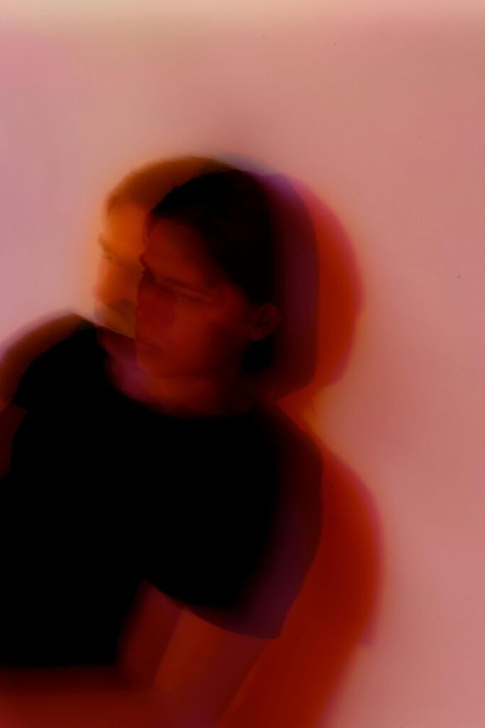 pexels-photo-4603590-4603590 Defocused anonymous young anxious male with split personality standing near wall with shade in twilight while looking away